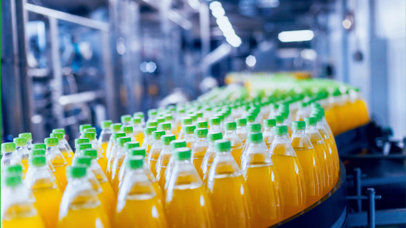 Orange bottled beverage in a production line.