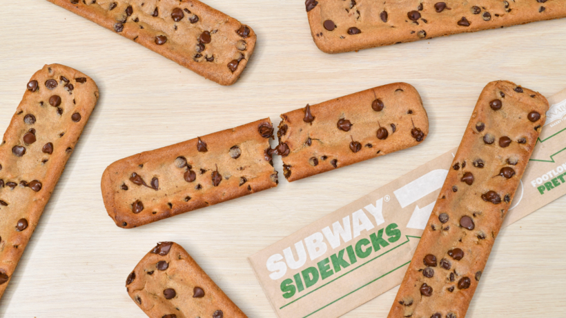 Two of Subway's Chocolate Chip Cookie Sidekicks on a countertop. 