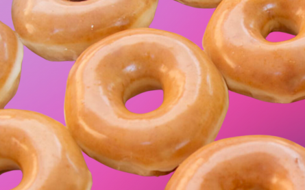 Krispy Kreme dougnuts on a pink background.