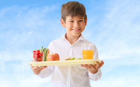 Young boy with school lunch tray