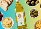 Table spread with olive oil, pasta, bread and olives